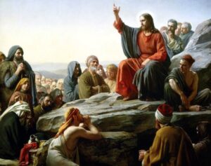 Jesus Christ teaching the crowds during the Sermon on the Mount, illustrating the concept of a trusted teaching guide and the Catholic Magisterium.